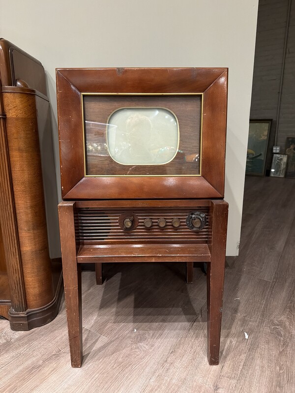 A Philco television in a wooden cabinet on legs