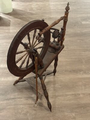 Wooden spinning wheel of the kind
