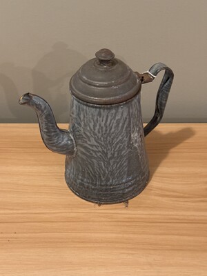 Humble metal teapot with a textured