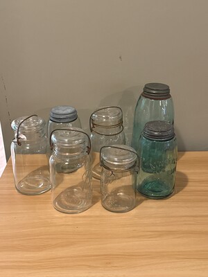 Grouping of clear glass jars of varying sizes and shapes