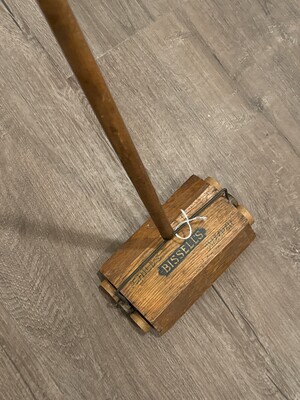 Bissell's manually operated carpet sweeper in wood and metal