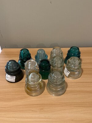 Grouping of ten vintage glass insulators in clear