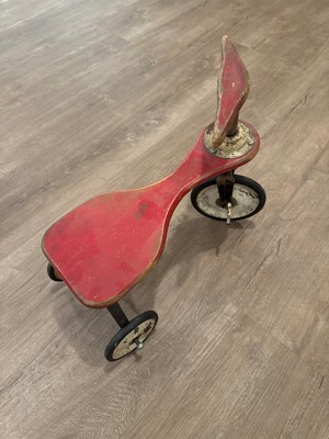 Child's wooden tricycle in faded red paint