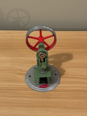 Small model flywheel engine in painted green and red metal