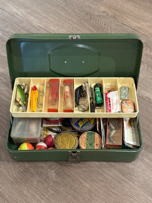 Open tackle box packed with the working kit of a lifelong angler