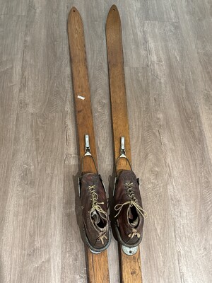 Pair of vintage wooden skis with aged leather bindings