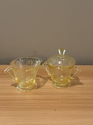 Matched creamer and sugar dish in uranium glass