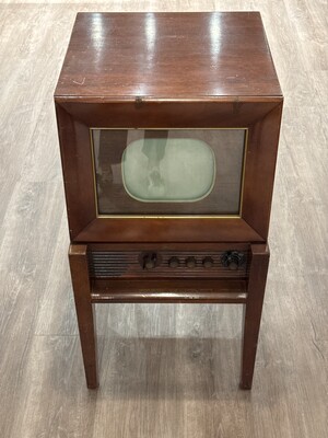 Early television set in a wooden cabinet