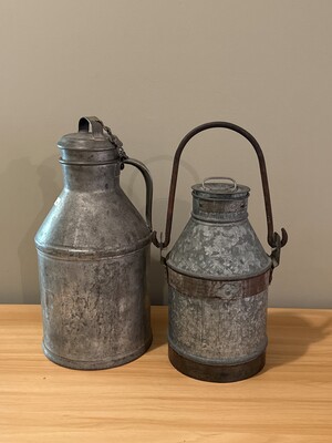 Pair of metal canisters with softly patinated surfaces
