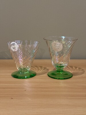Pair of small glass vessels with circular green bases and textured