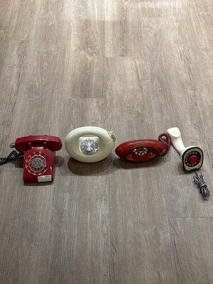 Grouping of four vintage telephones tracing the evolution of household