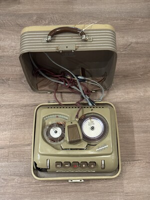 Mid-20th-century reel-to-reel tape recorder in a beige case