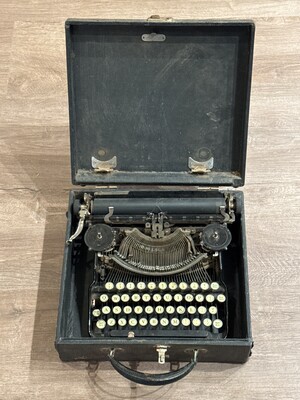 Vintage typewriter resting in its original black carrying case