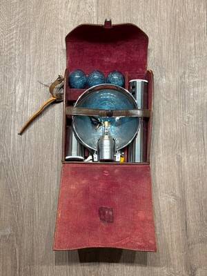Portable case lined in deep red velvet