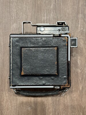 Unidentified object whose form suggests an old camera or similar