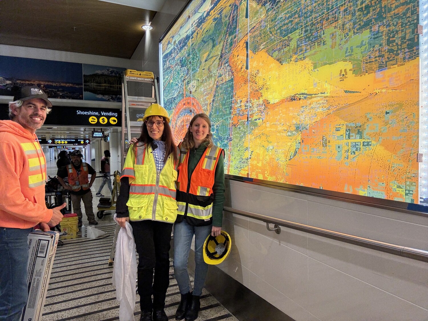 Tommy Gregory, Shuli Sade, and Annabelle Goavec, installing Sade’s *Hola* earlier this year at D3  COURTESY OF SEA AIRPORT