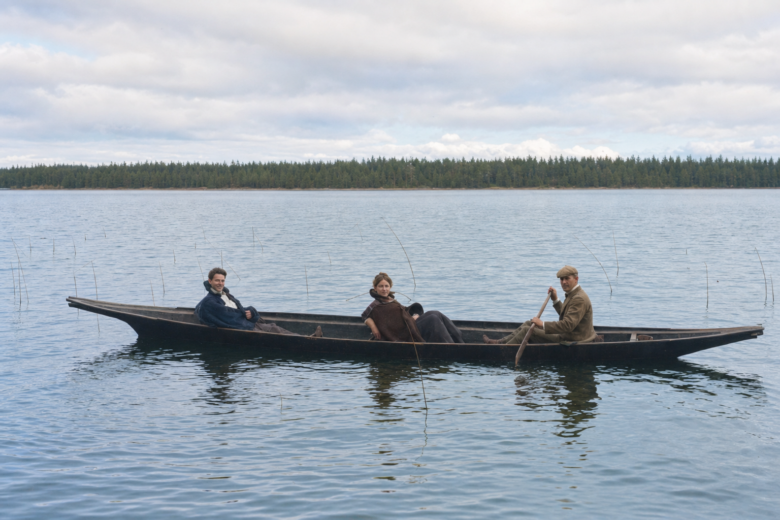 Three figures in a dugout canoe, Seattle, c. 1900