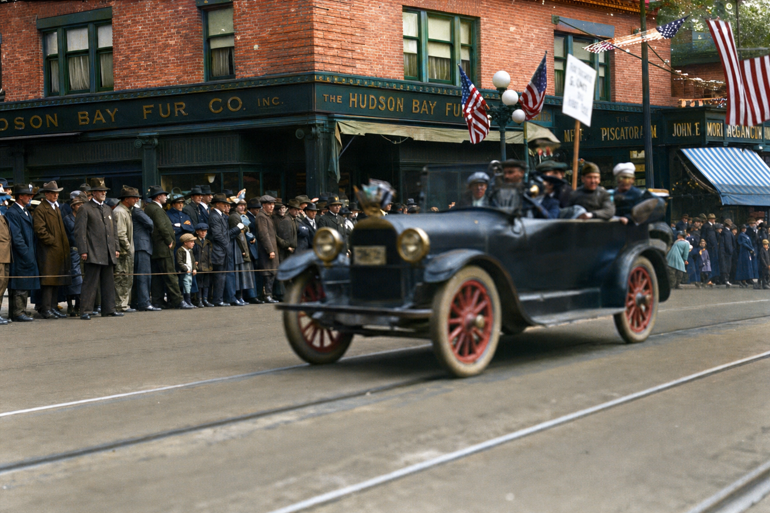 Parade automobile passing Hudson Bay Fur Co., c. 1918